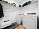 Bright laundry room with modern washer and dryer, practical shelving, and storage for everyday convenience at 1176 Sagamore Dr, Louisburg, NC 27549