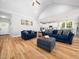 Open-concept living room with hardwood floors, and modern furniture, offering seamless flow at 1176 Sagamore Dr, Louisburg, NC 27549