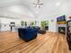 Open concept living room with hardwood floors, a fireplace, and plenty of natural light at 1176 Sagamore Dr, Louisburg, NC 27549