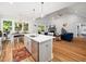 Open concept living space featuring a kitchen island, dining table and cozy fireplace at 1176 Sagamore Dr, Louisburg, NC 27549
