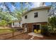 Rear of the home showing the screened porch, deck, and access to the lower level with a fenced yard for privacy at 1205 Willow Dr, Chapel Hill, NC 27517