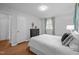 Serene bedroom with neutral tones, wood flooring, and a large window for natural light at 1205 Willow Dr, Chapel Hill, NC 27517