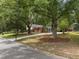Landscaped front yard with mature trees shading a beautiful home at 1205 Willow Dr, Chapel Hill, NC 27517