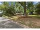 Charming brick and siding home with mature trees and a spacious front yard, perfect for outdoor activities at 1205 Willow Dr, Chapel Hill, NC 27517