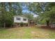 Traditional exterior with a well-maintained lawn, showcasing the house with brick accents and a cozy, inviting appeal at 1205 Willow Dr, Chapel Hill, NC 27517