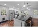 Modern kitchen features stainless steel appliances, a spacious island with bar seating, and ample cabinet space at 1205 Willow Dr, Chapel Hill, NC 27517