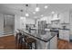 Modern kitchen with a large island, stainless steel appliances, and white cabinets for ample storage space at 1205 Willow Dr, Chapel Hill, NC 27517