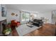 Cozy living room with hardwood floors, a fireplace, and large windows providing ample natural light at 1205 Willow Dr, Chapel Hill, NC 27517