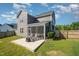 A beautiful backyard featuring a well-maintained lawn, a patio, and a screened-in porch area for relaxation at 123 Teaser Dr, Fuquay Varina, NC 27526