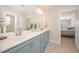 Bathroom boasts a blue dual sink vanity, a large mirror, and neutral flooring at 123 Teaser Dr, Fuquay Varina, NC 27526