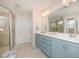 Bathroom boasts a dual sink vanity, a glass enclosed shower, and neutral flooring at 123 Teaser Dr, Fuquay Varina, NC 27526