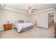 Primary bedroom featuring a ceiling fan, tray ceiling and neutral carpeting at 123 Teaser Dr, Fuquay Varina, NC 27526