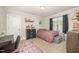 Well-lit bedroom with study desk, mauve-toned bed linens, and neutral carpeting at 123 Teaser Dr, Fuquay Varina, NC 27526