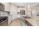 Kitchen with stainless sink and faucet, granite counters, and a breakfast bar with storage at 123 Teaser Dr, Fuquay Varina, NC 27526