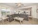 Open-concept living room with a view of the kitchen, featuring a large sectional and neutral decor at 123 Teaser Dr, Fuquay Varina, NC 27526