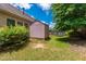 View of a backyard with a shed, lawn, and mature trees at 1320 Cozy Oak Ave, Cary, NC 27519