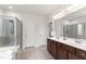 Bright bathroom featuring a double sink vanity, and a glass-enclosed shower at 1320 Cozy Oak Ave, Cary, NC 27519
