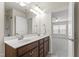 Bright bathroom featuring a double sink vanity next to an ensuite bedroom at 1320 Cozy Oak Ave, Cary, NC 27519