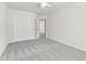 Bedroom features neutral carpet, ceiling fan, and double-door closet at 1320 Cozy Oak Ave, Cary, NC 27519