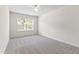 Well-lit bedroom features neutral carpet, ceiling fan, and sunny window at 1320 Cozy Oak Ave, Cary, NC 27519