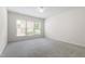 Bright bedroom with neutral carpet, a ceiling fan, and large windows offering natural light at 1320 Cozy Oak Ave, Cary, NC 27519