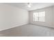 Bright bedroom features neutral carpet, ceiling fan, and a window with blinds at 1320 Cozy Oak Ave, Cary, NC 27519