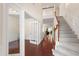 Spacious entryway with hardwood floors, staircase, and a glimpse into other living spaces at 1320 Cozy Oak Ave, Cary, NC 27519