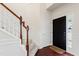 Elegant entryway showcasing a staircase with carpeted steps and a dark wood banister at 1320 Cozy Oak Ave, Cary, NC 27519