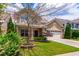 Charming two-story home featuring a manicured lawn and a two-car garage, exuding curb appeal at 1320 Cozy Oak Ave, Cary, NC 27519
