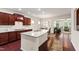 Spacious kitchen with a large island, granite countertops, stainless steel appliances, and open view to living room at 1320 Cozy Oak Ave, Cary, NC 27519