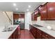 Spacious kitchen featuring stainless steel appliances, granite countertops, and dark wood cabinets at 1320 Cozy Oak Ave, Cary, NC 27519