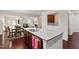 Kitchen island featuring granite countertop, stainless steel sink and view to dining area and living room at 1320 Cozy Oak Ave, Cary, NC 27519