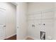 Bright laundry room features shelving and connections for washer and dryer at 1320 Cozy Oak Ave, Cary, NC 27519