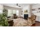 Comfortable living room featuring a fireplace, built-in shelving, and large windows for natural light at 1320 Cozy Oak Ave, Cary, NC 27519