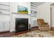 Living room fireplace with decorative mantle and built-in shelving providing storage space at 1320 Cozy Oak Ave, Cary, NC 27519
