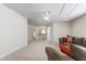 Large loft area with neutral carpeting, ceiling fan, and staircase view at 1320 Cozy Oak Ave, Cary, NC 27519