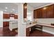 Bright office area featuring a granite countertop desk with wooden cabinets, overlooking kitchen and dining area at 1320 Cozy Oak Ave, Cary, NC 27519
