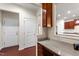 Bright office area featuring a granite countertop desk with wooden cabinets and view to the kitchen at 1320 Cozy Oak Ave, Cary, NC 27519