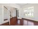 Bright home office with hardwood floors, white trim, and a glass-paneled door at 1320 Cozy Oak Ave, Cary, NC 27519
