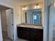 Bathroom with double sink vanity with granite countertops and wood cabinets at 14 Gallop Rein Cir, Benson, NC 27504