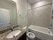 Clean bathroom with a granite vanity and a tiled shower-tub combination at 14 Gallop Rein Cir, Benson, NC 27504