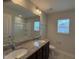 Double sink vanity with granite countertops and a large mirror at 14 Gallop Rein Cir, Benson, NC 27504