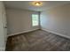 Bright bedroom with carpet floors, neutral walls, and a window at 14 Gallop Rein Cir, Benson, NC 27504
