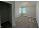 Bedroom featuring neutral carpet, a closet, and large windows for natural light at 14 Gallop Rein Cir, Benson, NC 27504