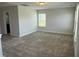 This carpeted bedroom has a window with bright natural light, and a bathroom attached to the side at 14 Gallop Rein Cir, Benson, NC 27504