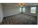 Spacious main bedroom featuring tray ceilings, neutral walls, and carpet floors at 14 Gallop Rein Cir, Benson, NC 27504