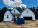 New construction home with covered front porch and two-car garage on a sunny day at 146 Seahawk Way, Zebulon, NC 27597