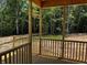 A wooden porch offers a peaceful view of trees and lush greenery at 146 Seahawk Way, Zebulon, NC 27597