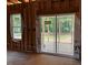 An unfinished room featuring a sliding glass door leading to a porch with wooded views at 146 Seahawk Way, Zebulon, NC 27597