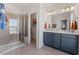Modern bathroom featuring a double vanity, a large shower with glass door, and stylish fixtures at 1501 Village Hall Ln # 38, Wake Forest, NC 27587